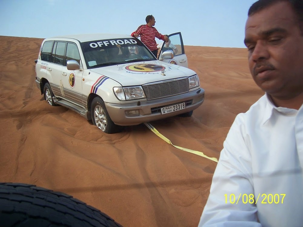 Our driver helping his fellow driver to jump start his vehicle in the desert