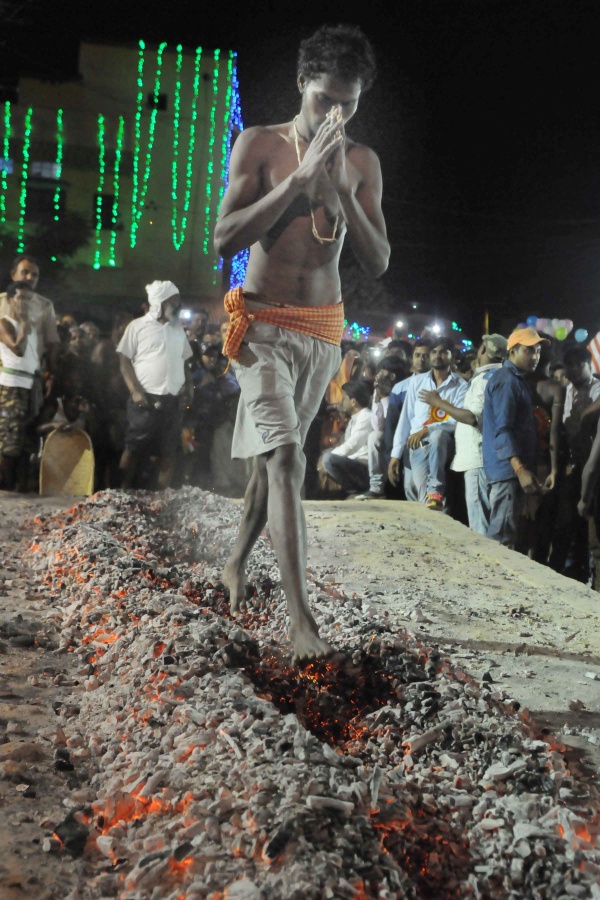 Manda Festival: A devotee is walking on burning coals