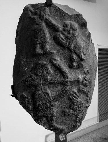 Art on volcanic rock depicting King Ashurnasirpal killing lions using spear and arrows